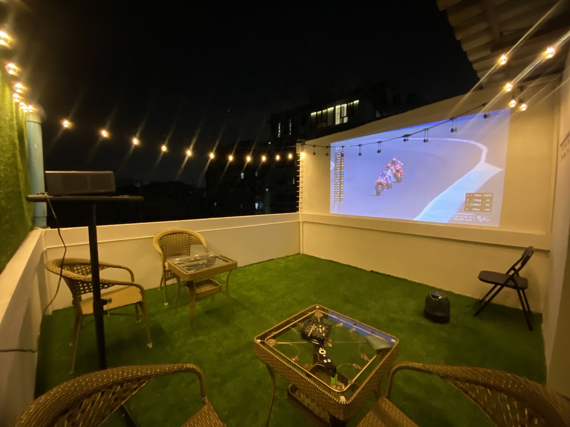 HOLYWEED Sathorn rooftop terrace with lounge seating and outdoor screening area